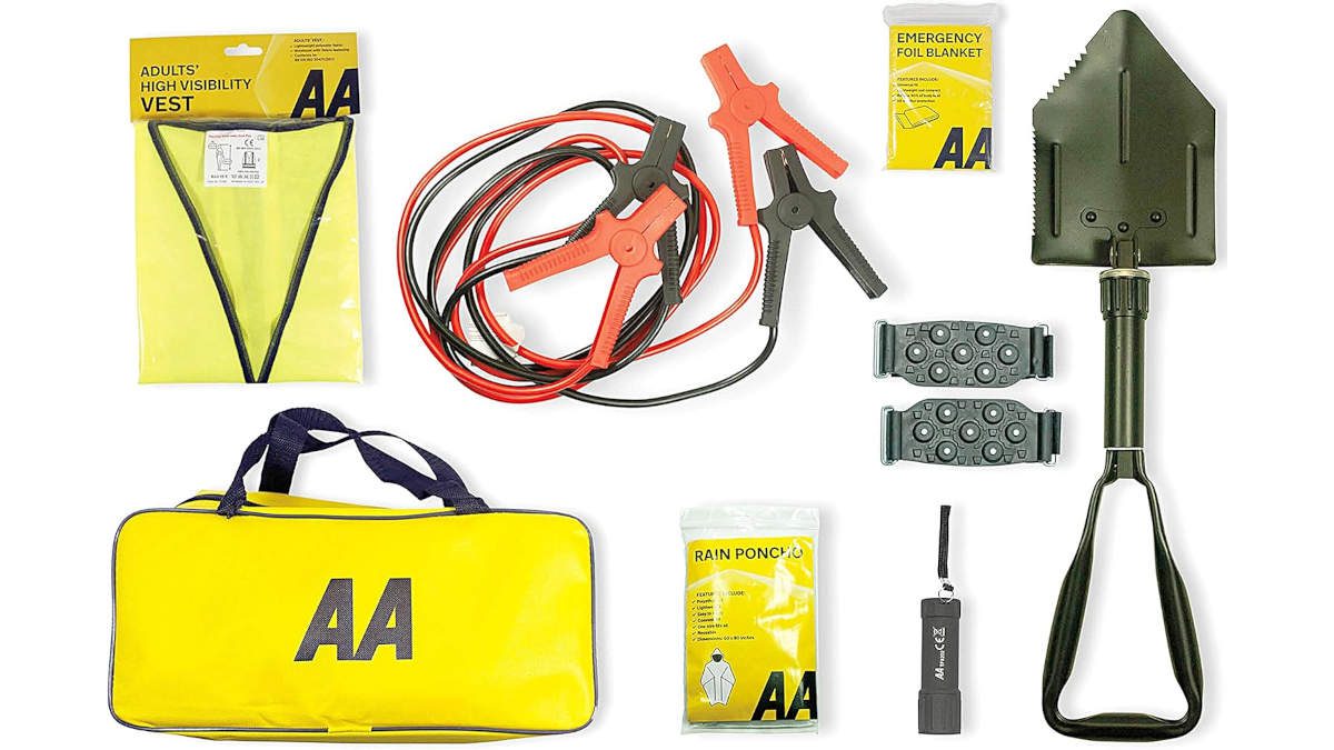 AA winter car kit contents laid flat — yellow AA holdall, jump leads, adults high-visibility vest, folding army shovel, snow grips, rain poncho, emergency foil blanket, and LED torch — UK Prepper Hub